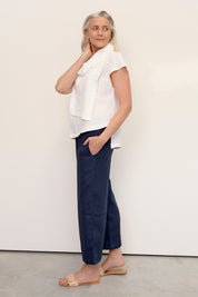 Model wears Hazel Linen Top Warm White with soft fall cowl neck