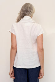 Back of model wearing Hazel Linen Top Warm White with soft fall cowl neck