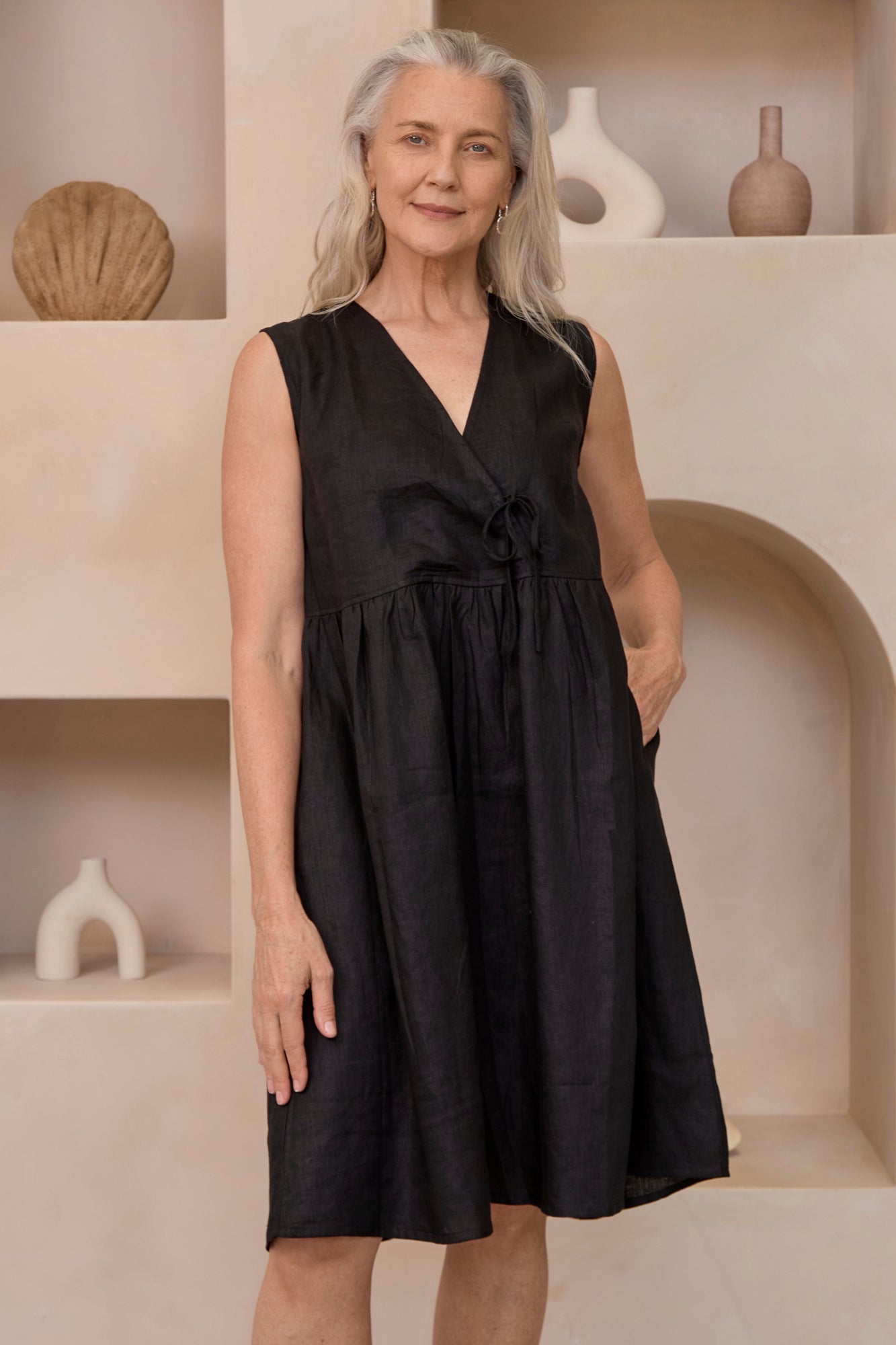 Model wears Tatum Linen Dress Black with a v-neck and tie side detail