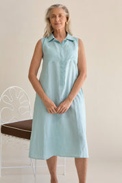 Woman wearing the Samara Linen Dress Sea, showcasing the dress's elegant design.