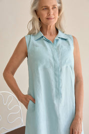 Woman wearing the Samara Linen Dress Sea, showcasing the dress's elegant design.