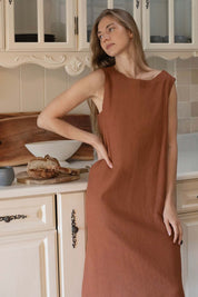 Woman wearing a Cynthia Linen Dress Bark, showcasing its versatile and elegant design.