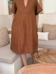 Close-up of the Charlotte Linen Dress Bark featuring pockets and elegant sleeve design.