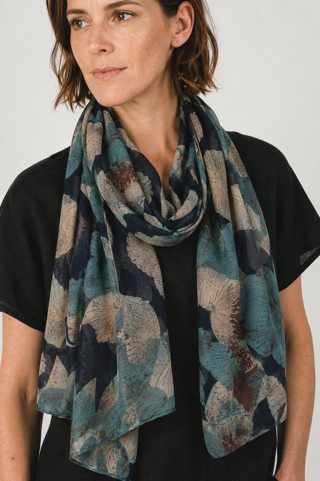 Navy Abstract Floral Scarf elegantly draped around a woman's neck, featuring a navy botanical design.
