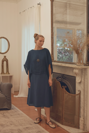 Model wearing Camilla Linen Gauze Top Navy layered over the Cynthia Dress Navy showcasing effortless layering and light coverage.