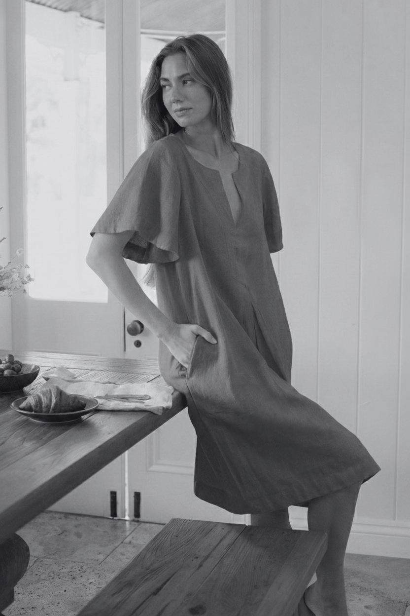 Model wearing the new Charlotte Linen Dress Bark featuring pockets and elegant sleeve design.