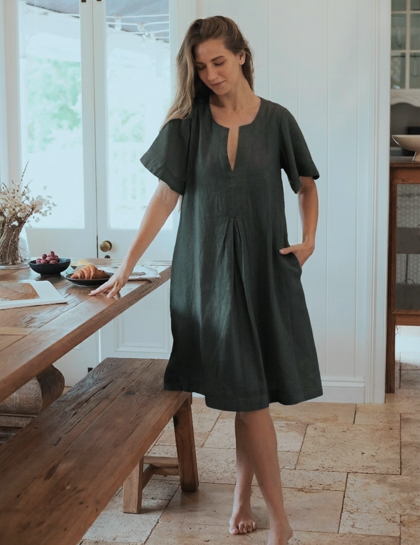 Model wearing Charlotte Linen Dress Charcoal, showcasing effortless elegance with a sleeve.