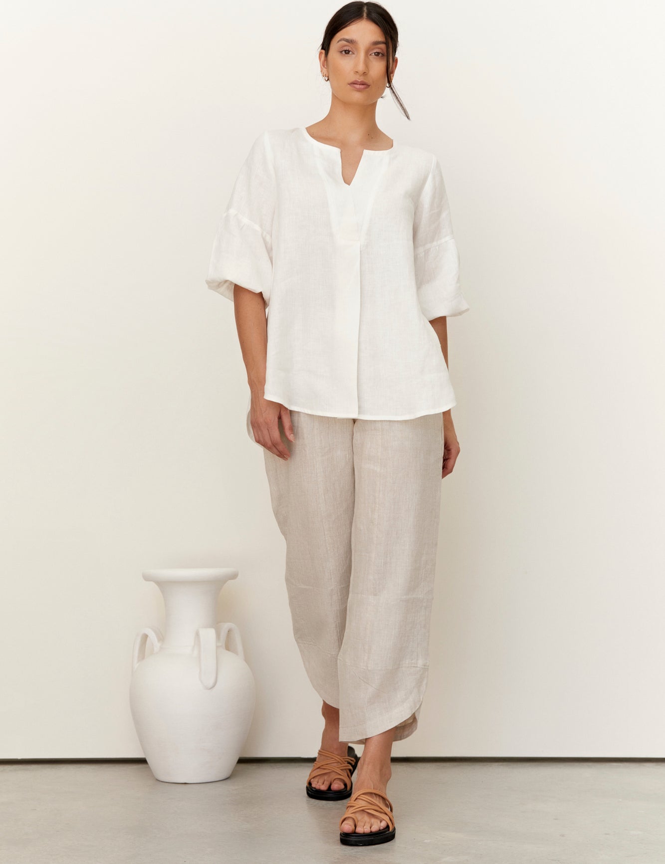 Clancy Linen Top Warm White worn by a model, showcasing its relaxed fit and elegant design.