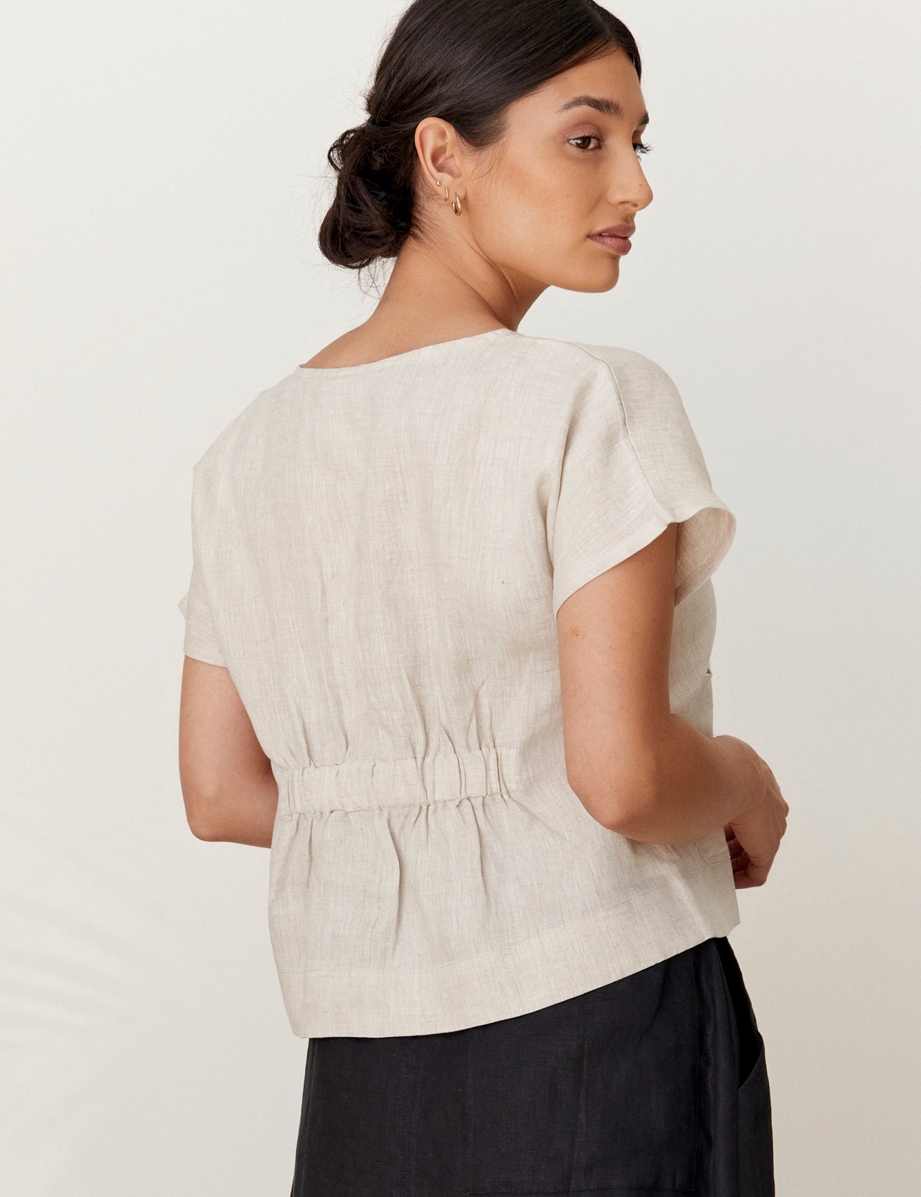 Model wears Zoe Linen Top Natural with black linen skirt