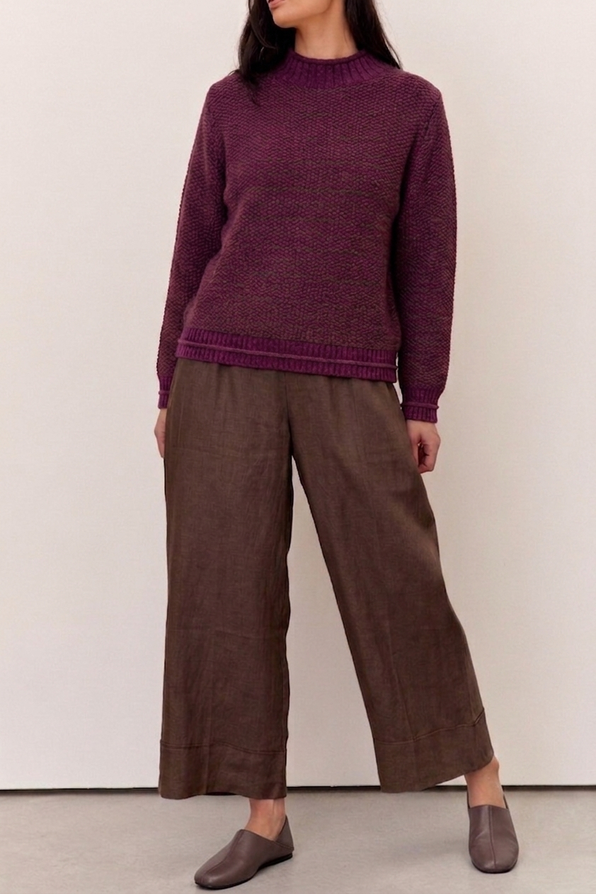 Model wearing a Willow Deep Plum Cotton Blend Jumper paired with brown wide-legged pants.