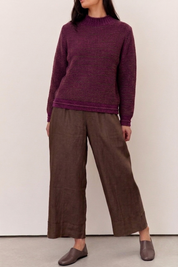 Model wearing a Willow Deep Plum Cotton Blend Jumper paired with brown wide-legged pants.